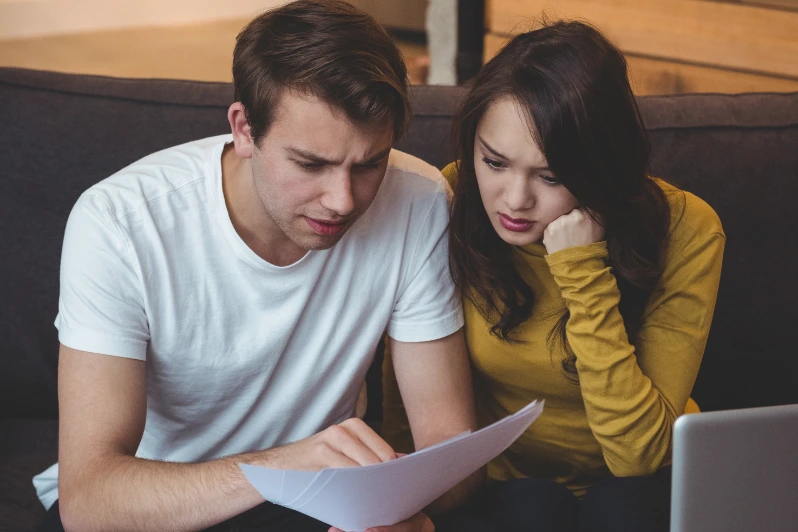 couple sitting and worried for the spouse documents being rejected